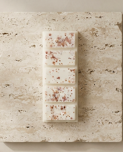 Sofia Dourvari Choco Hazelnut snap bar wax melt with soft blush and brown speckle inclusions, laid flat on a travertine stone