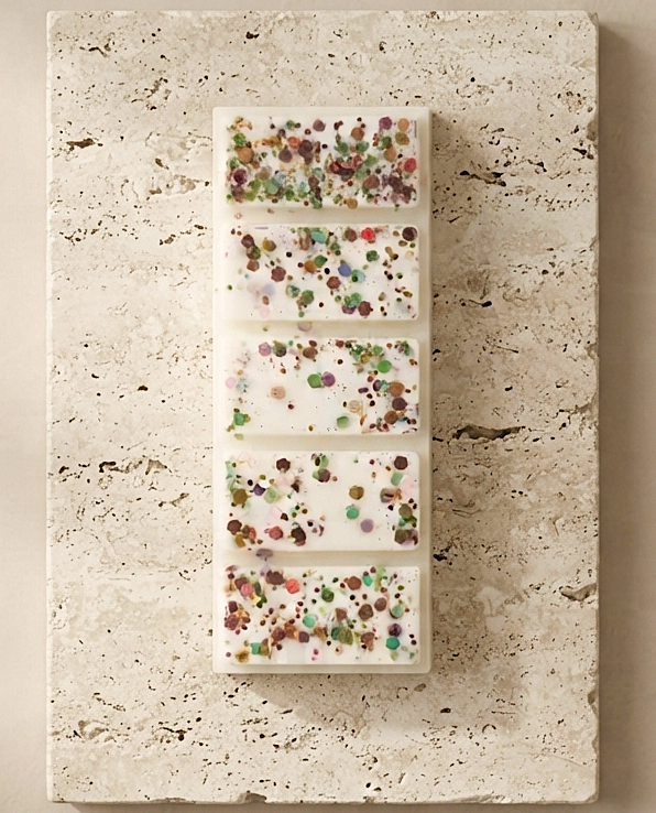 Sofia Dourvari Dubai Chocolate snap bar wax melt with vibrant multicolour confetti inclusions, displayed flat on a travertine stone